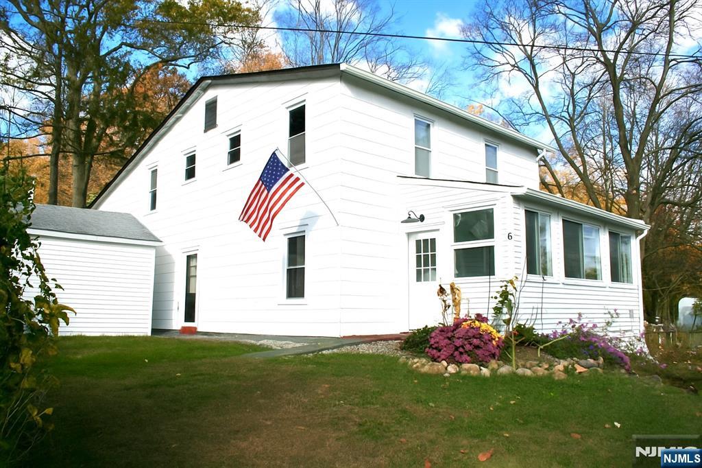 6 Bird Lane, Unit 2 Lake Hopatcong, NJ 07849 - Photo 1 of 7 a view of a white house with a yard