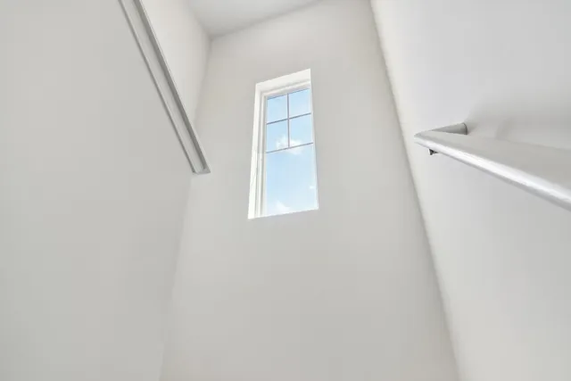 an entryway with stairs and a window