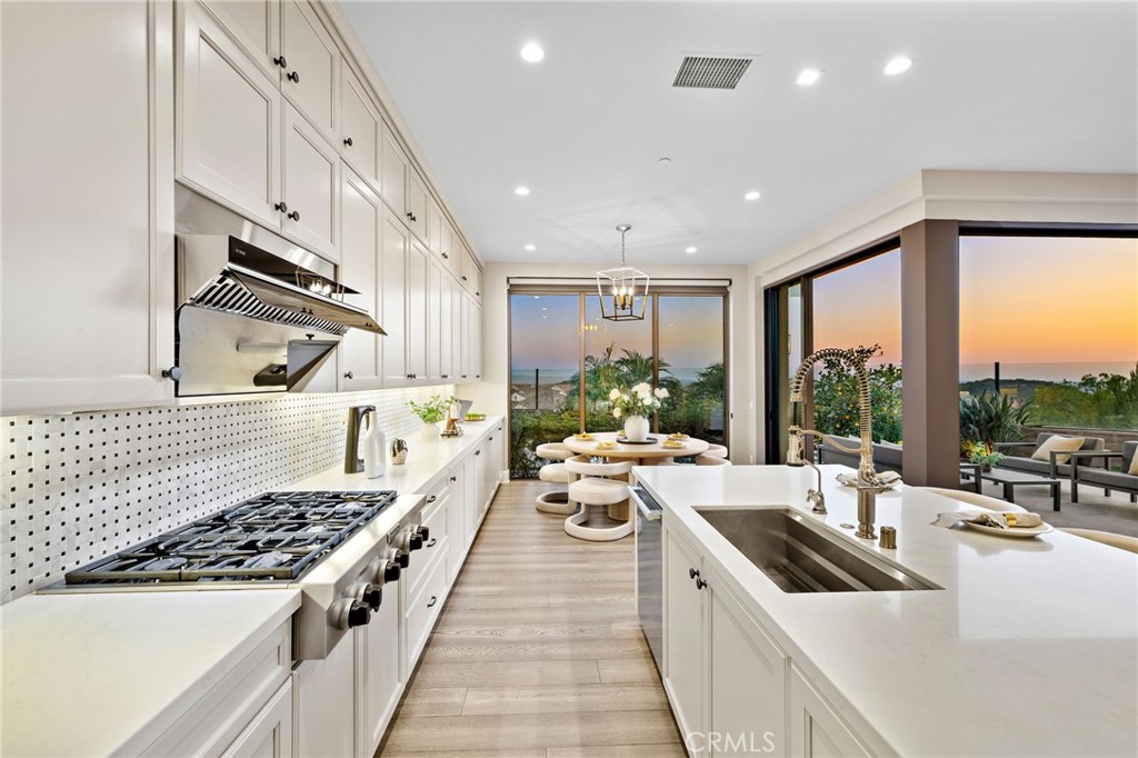 168 Bellini Irvine, CA 92602 - Photo 11 of 29 a large white kitchen with a large window and stainless steel appliances