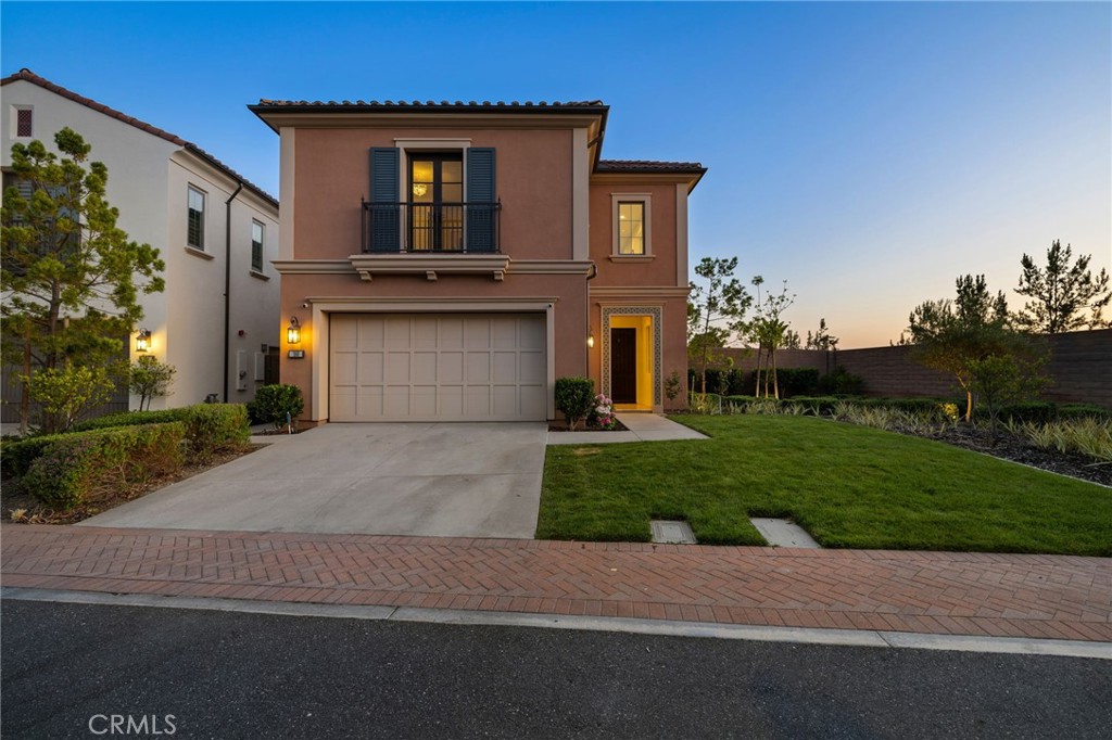 168 Bellini Irvine, CA 92602 - Photo 2 of 29 a front view of a house with a yard and a garage
