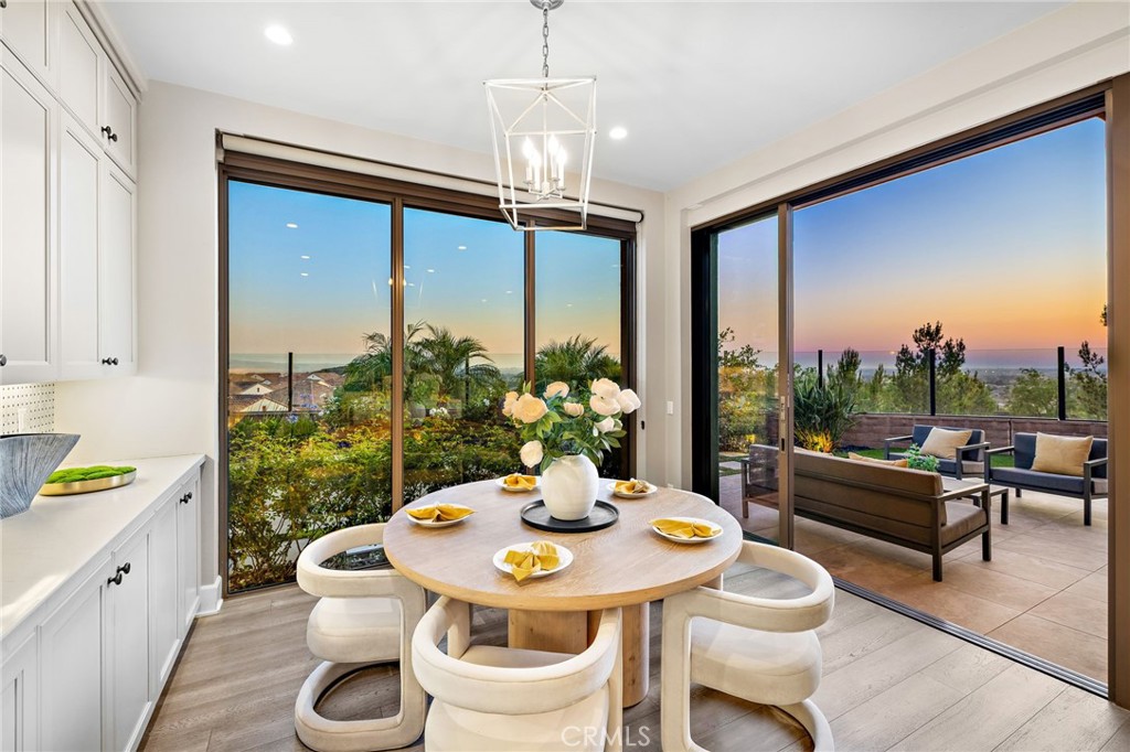168 Bellini Irvine, CA 92602 - Photo 9 of 29 a view of a dining room with furniture a chandelier and wooden floor