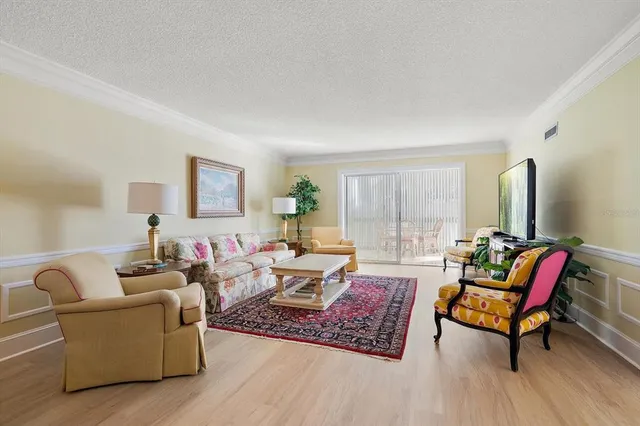 a living room with furniture rug and wooden floor