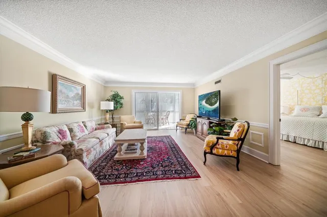 a living room with furniture or couch and a wooden floor