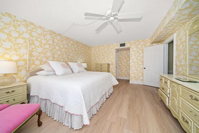 a spacious bedroom with a bed and a chandelier