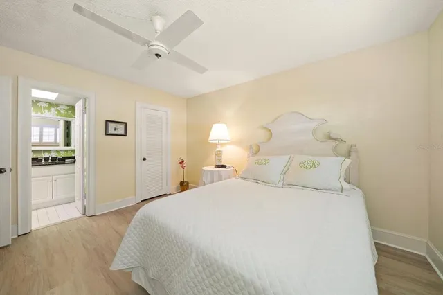 a bedroom with a large bed and a chandelier