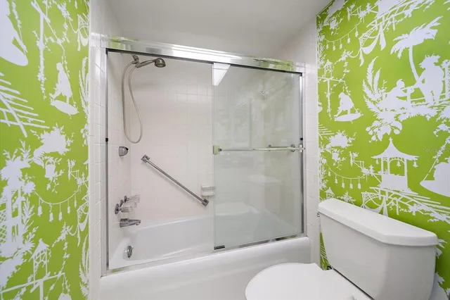 a bathroom with a toilet and a shower