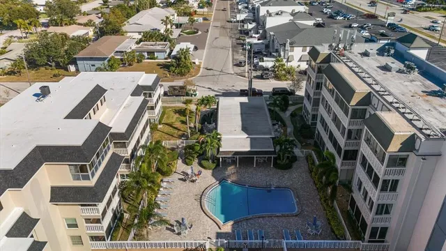 an aerial view of a residential apartment building with a yard