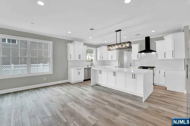 a kitchen with stainless steel appliances kitchen island wooden cabinets and granite counter tops