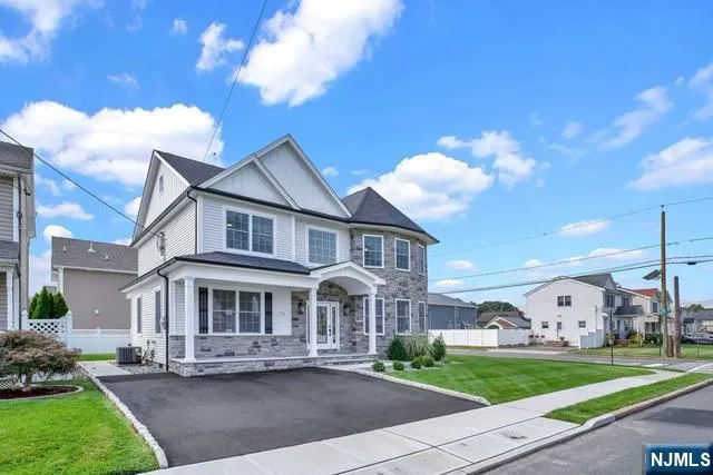 a front view of a house with a garden and plants