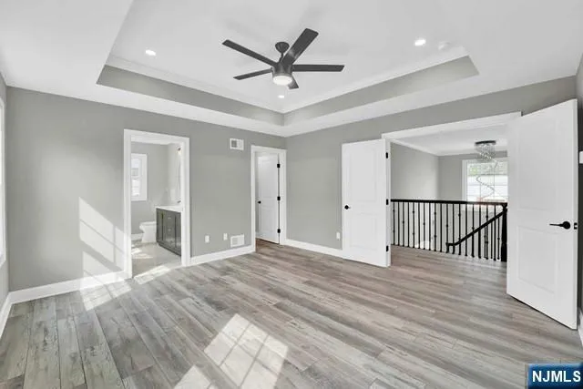 a view of a livingroom with a ceiling fan and wooden floor