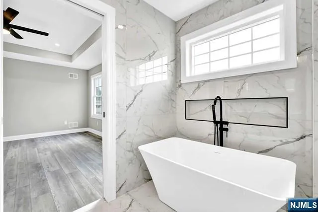 a bathroom with a bathtub and a window