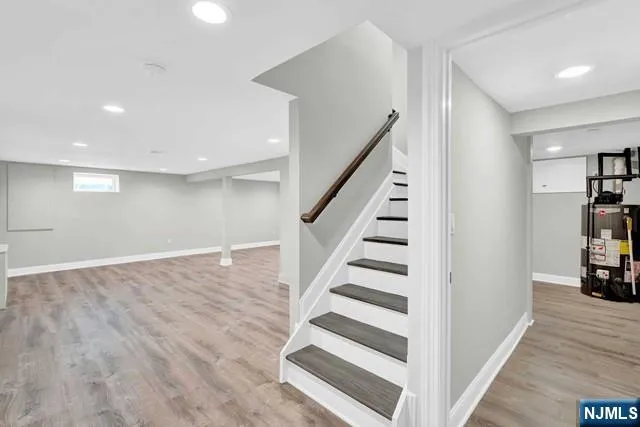 a view of a livingroom with wooden floor and stairs