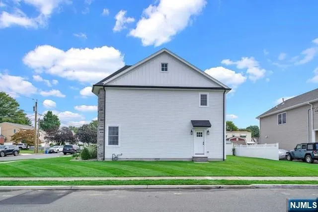 a front view of a house with a garden and garage