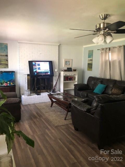 5701 Old Plank Road Charlotte, NC 28216 - Photo 6 of 10 a living room with furniture a chandelier and a flat screen tv