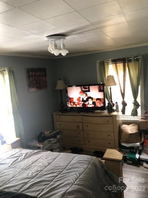 5701 Old Plank Road Charlotte, NC 28216 - Photo 8 of 10 a bedroom with a bed and a flat tv screen