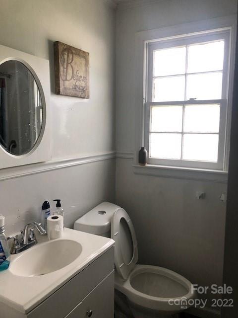 5701 Old Plank Road Charlotte, NC 28216 - Photo 10 of 10 a bathroom with a toilet a sink and a mirror