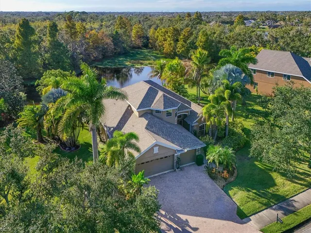 a aerial view of a house with a yard and potted plants