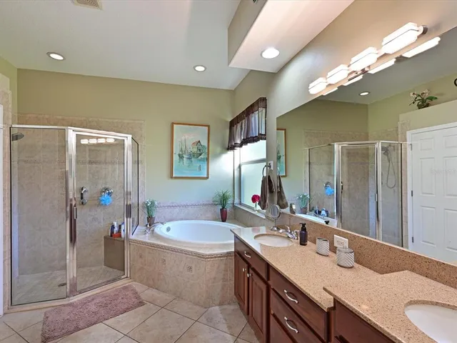 a bathroom with a granite countertop sink mirror and shower