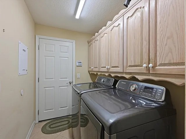 a view of kitchen island with a sink a stove and furniture