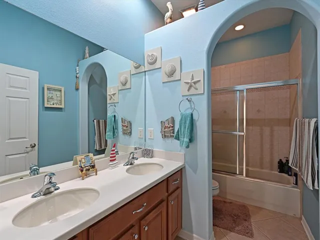 a bathroom with a double vanity sink and a mirror