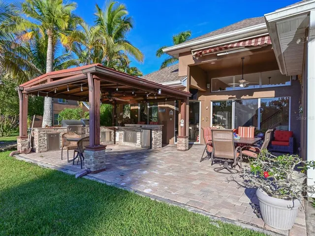 a view of a sitting area with chairs and table in a patio