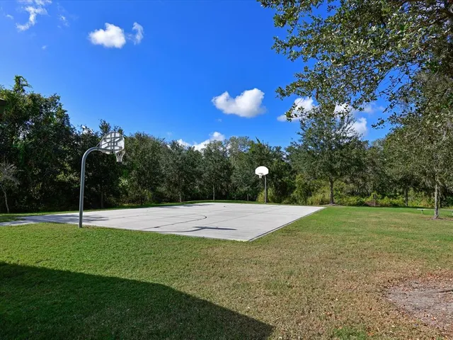 a view of an outdoor space and basketball court