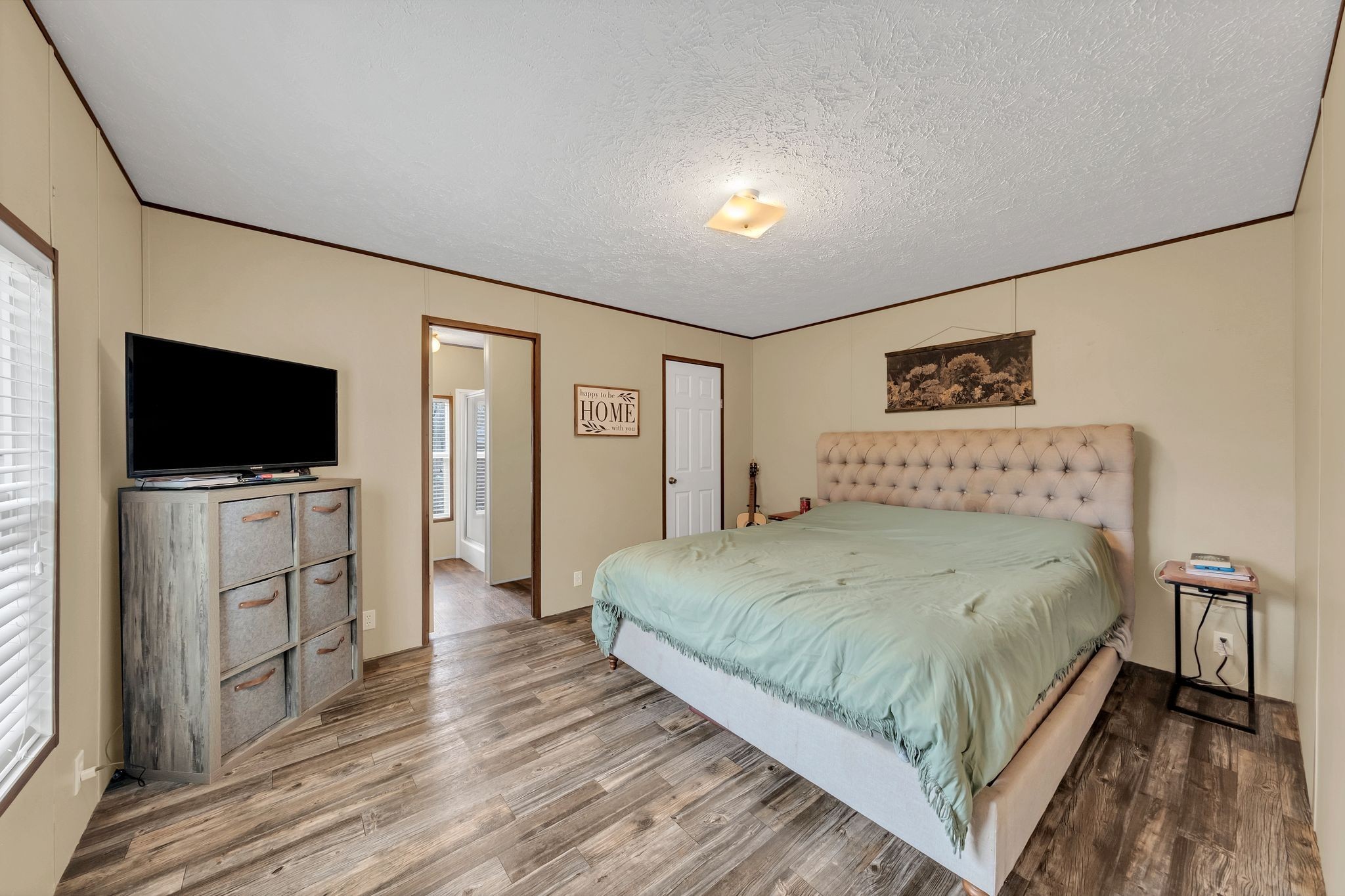 6126 Calvin Potts Road Primm Springs, TN 38476 - Photo 15 of 22 a bedroom with a bed and a flat screen tv