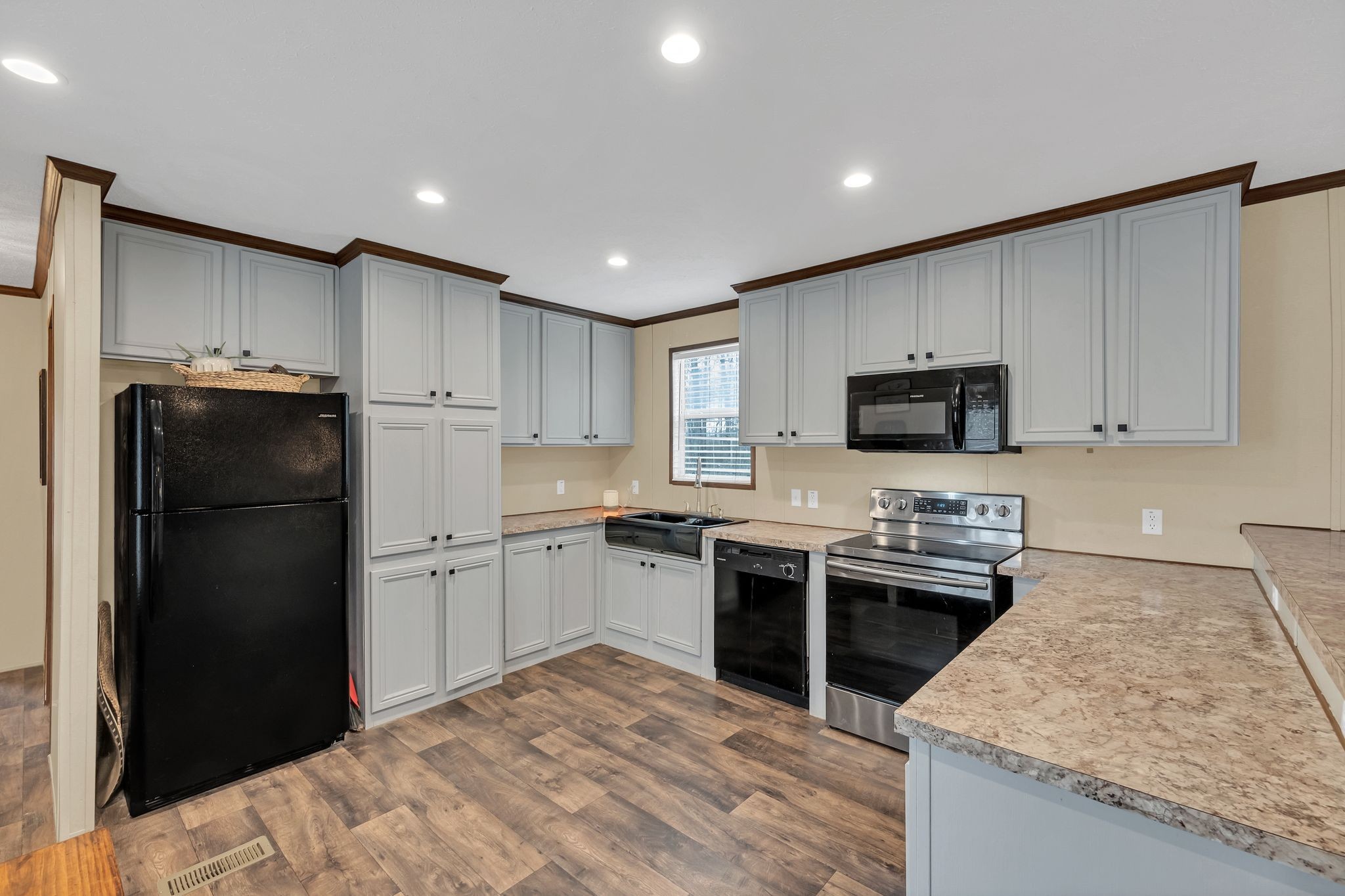 6126 Calvin Potts Road Primm Springs, TN 38476 - Photo 9 of 22 a kitchen with stainless steel appliances granite countertop a refrigerator stove top oven and sink
