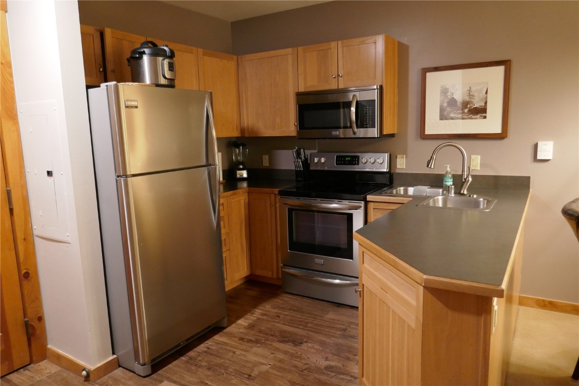 100 Dercum Square, Unit 8374 Keystone, CO 80435 - Photo 6 of 24 a white refrigerator freezer and a stove sitting inside of a kitchen