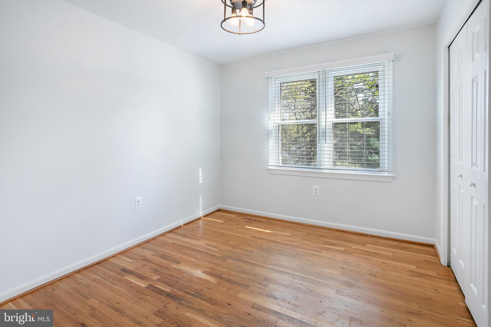 1420 Billman Lane Silver Spring, MD 20902 - Photo 13 of 44 an empty room with wooden floor and windows