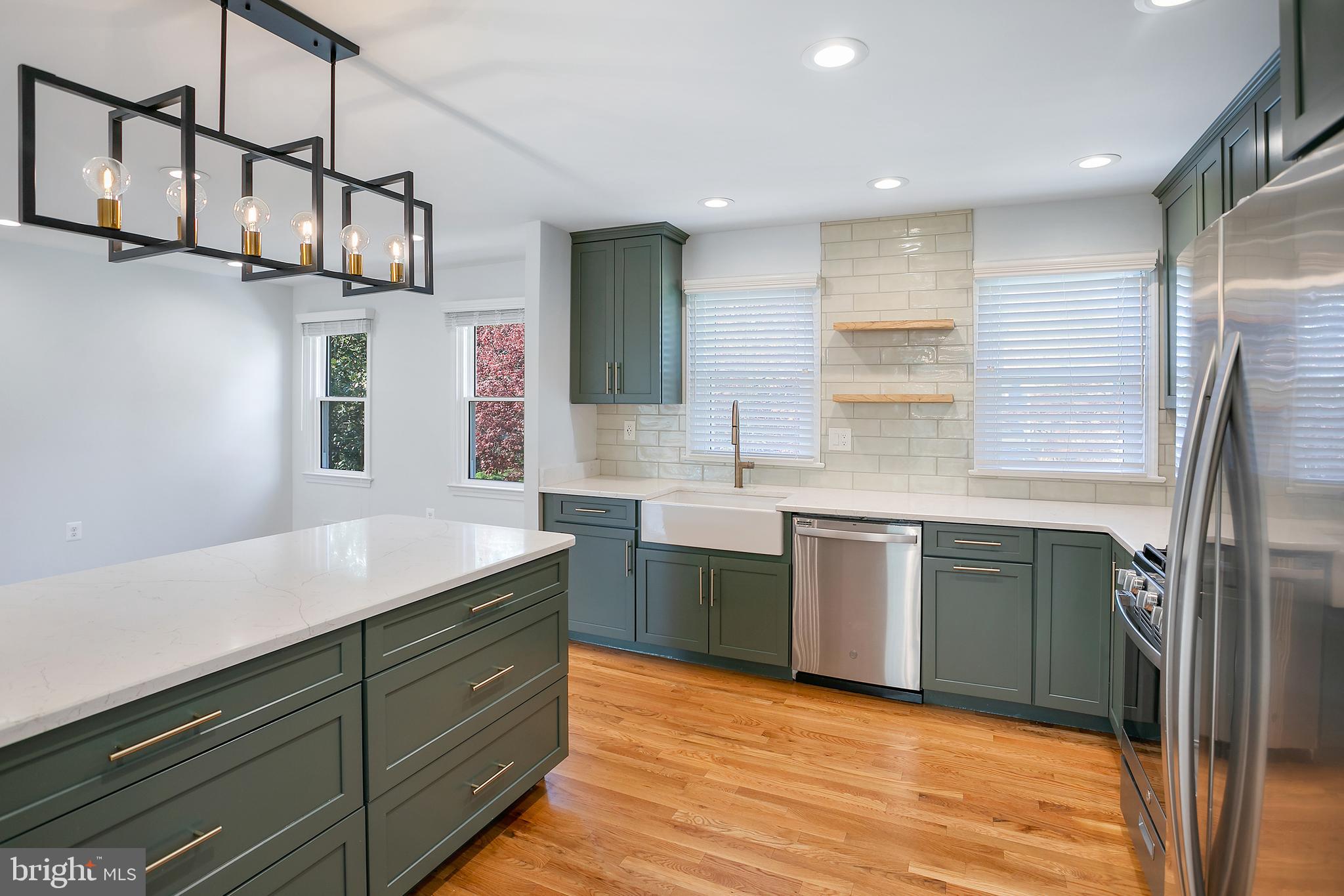 1420 Billman Lane Silver Spring, MD 20902 - Photo 7 of 44 a kitchen with stainless steel appliances granite countertop a sink a stove and refrigerator