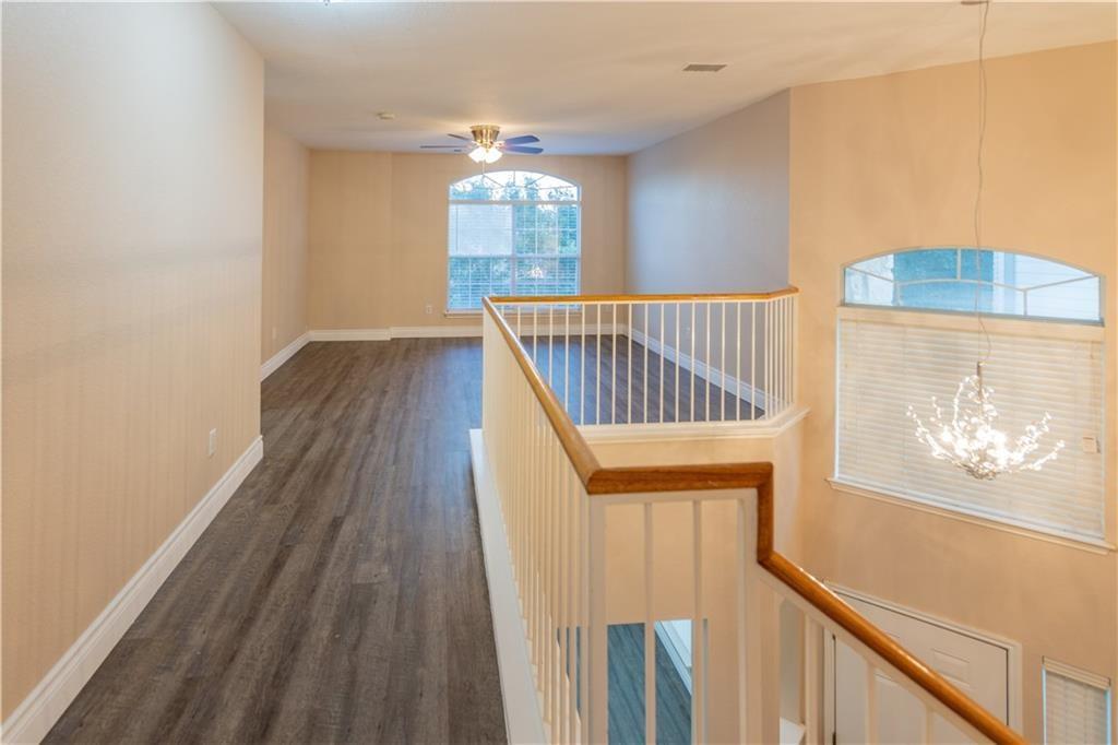 12017 Springs Head Loop Austin, TX 78717 - Photo 11 of 25 A graceful staircase with wood flooring guides you to an airy landing, bathed in natural light.