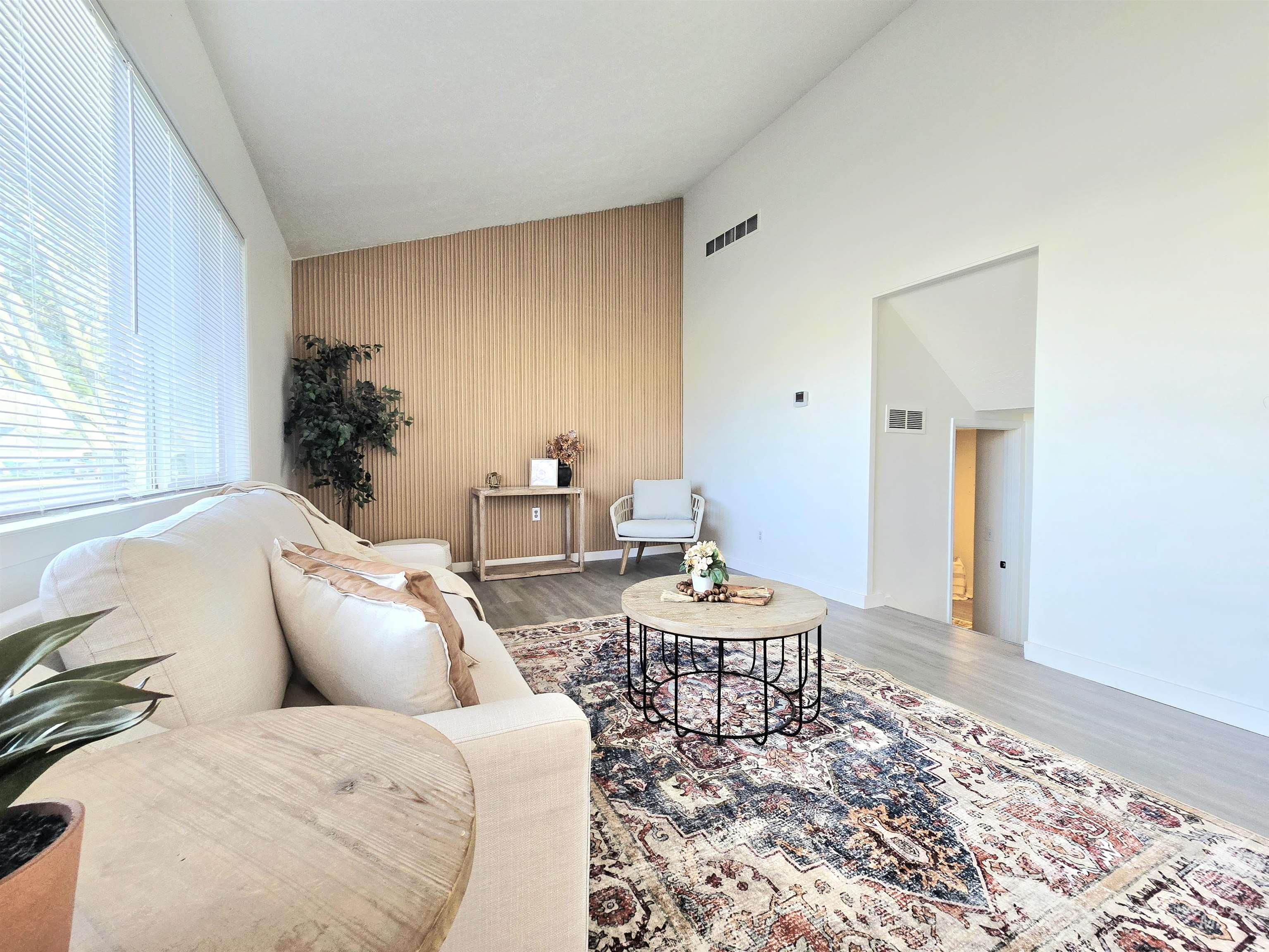 728 Northwest 8th Street Meridian, ID 83642 - Photo 1 of 18 Living room with an accent wall, lofted ceiling, and light wood-type flooring