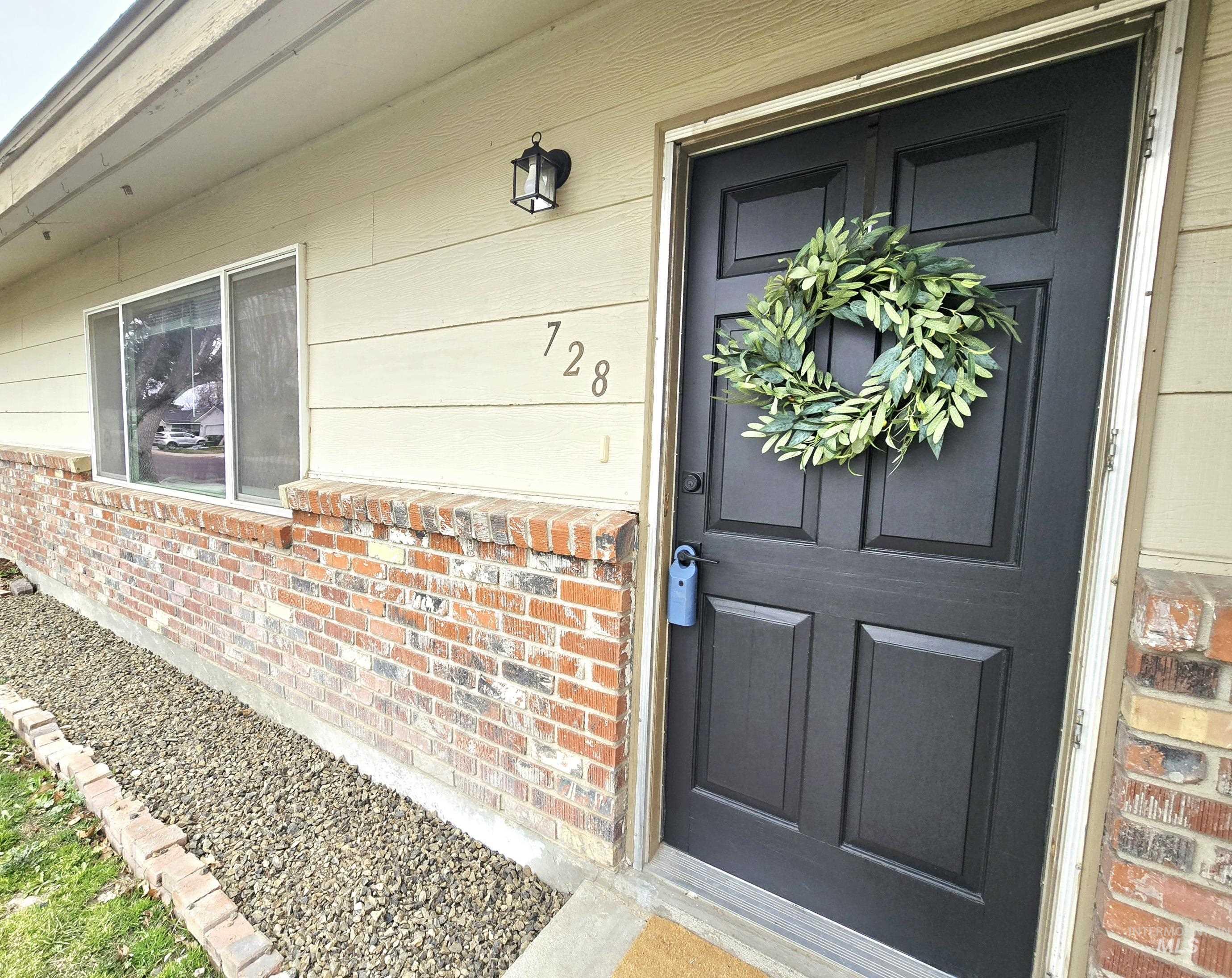 728 Northwest 8th Street Meridian, ID 83642 - Photo 12 of 18 Doorway to property featuring brick siding