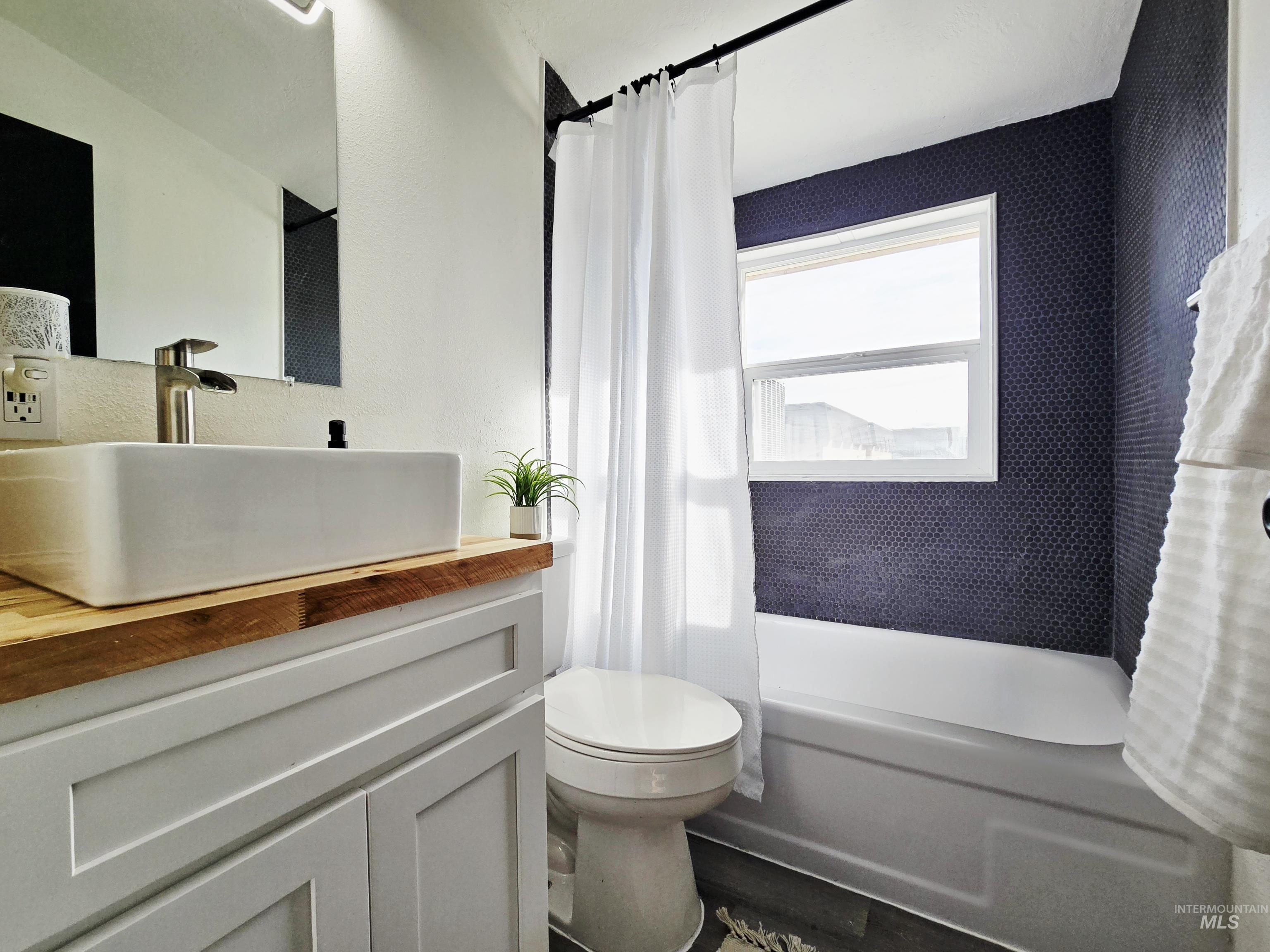 728 Northwest 8th Street Meridian, ID 83642 - Photo 16 of 18 Bathroom with shower / bathtub combination with curtain and vanity
