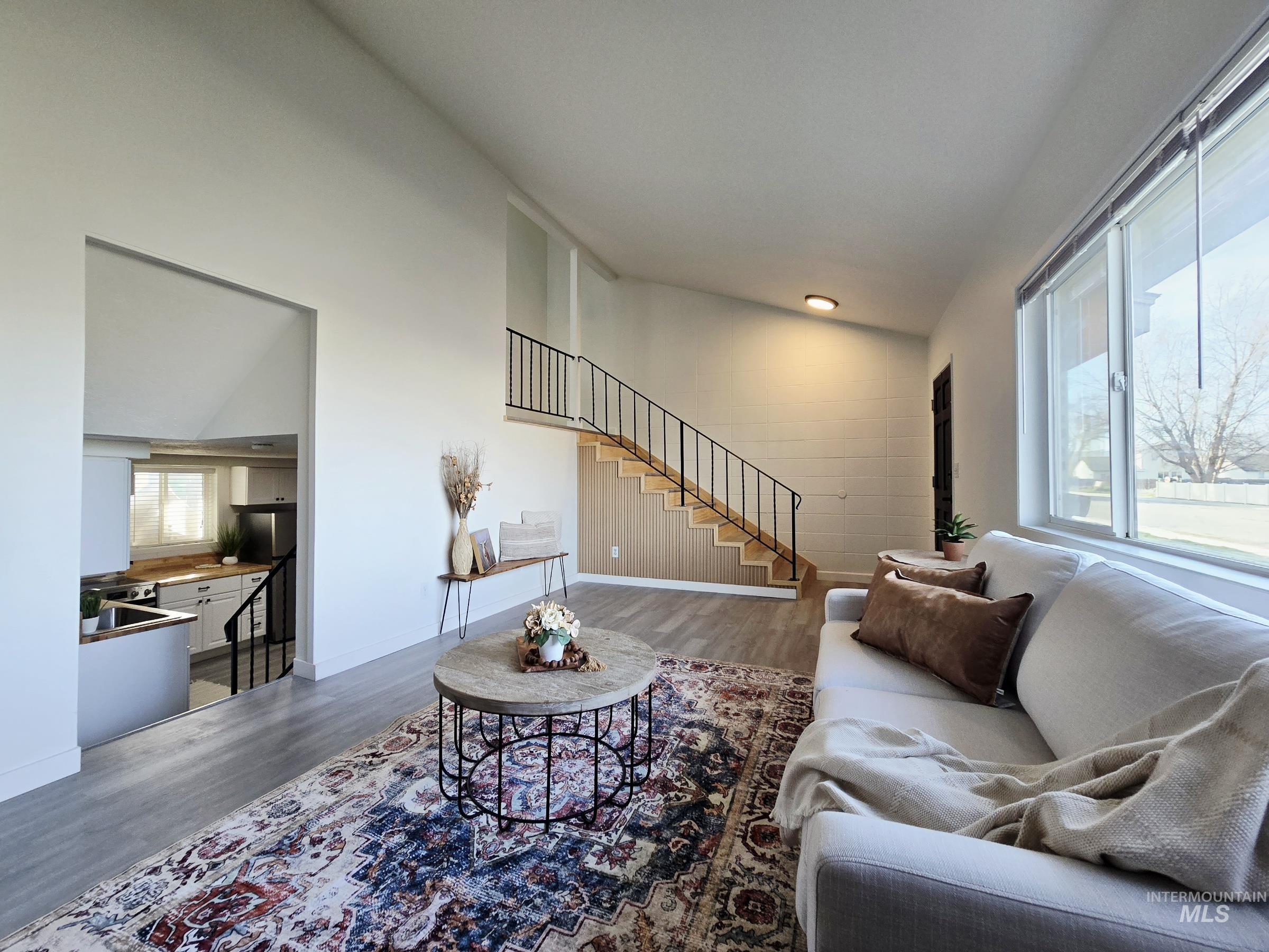 728 Northwest 8th Street Meridian, ID 83642 - Photo 2 of 18 Living room with wood finished floors and vaulted ceiling