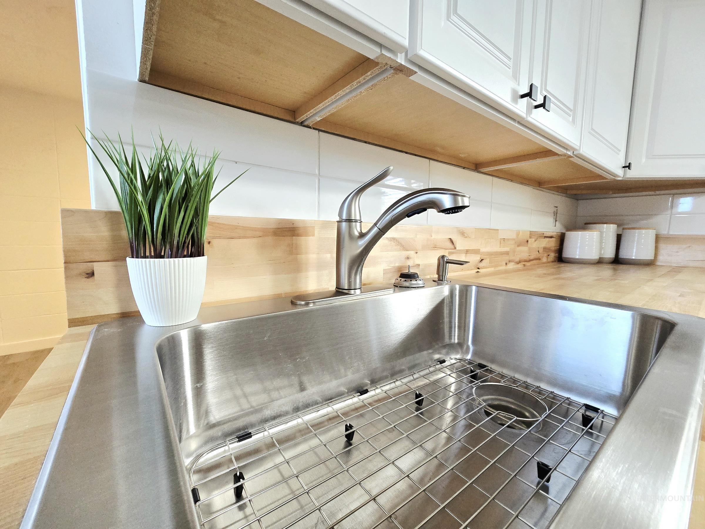 728 Northwest 8th Street Meridian, ID 83642 - Photo 8 of 18 Kitchen view of white cabinets and a sink