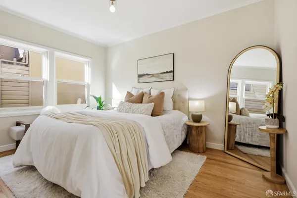 a bedroom with bed and a night stand