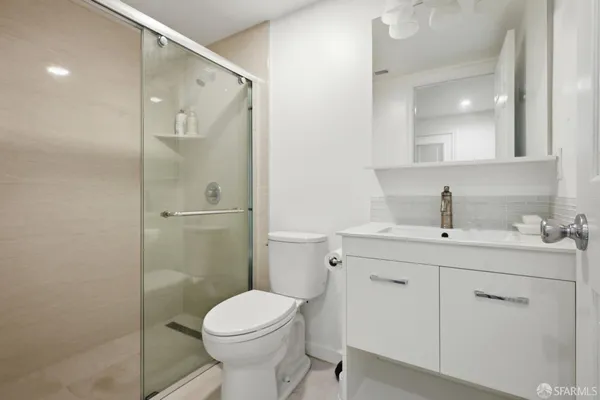 a bathroom with a toilet sink shower and mirror