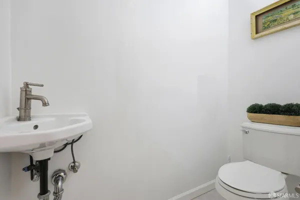a bathroom with a sink a toilet and mirror