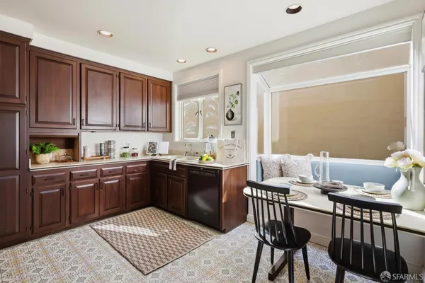 a kitchen with stainless steel appliances granite countertop a stove a sink dishwasher and cabinets