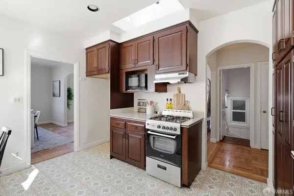 a kitchen with stainless steel appliances a stove a refrigerator and a cabinets