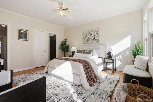 a spacious bedroom with a bed a couch and a window