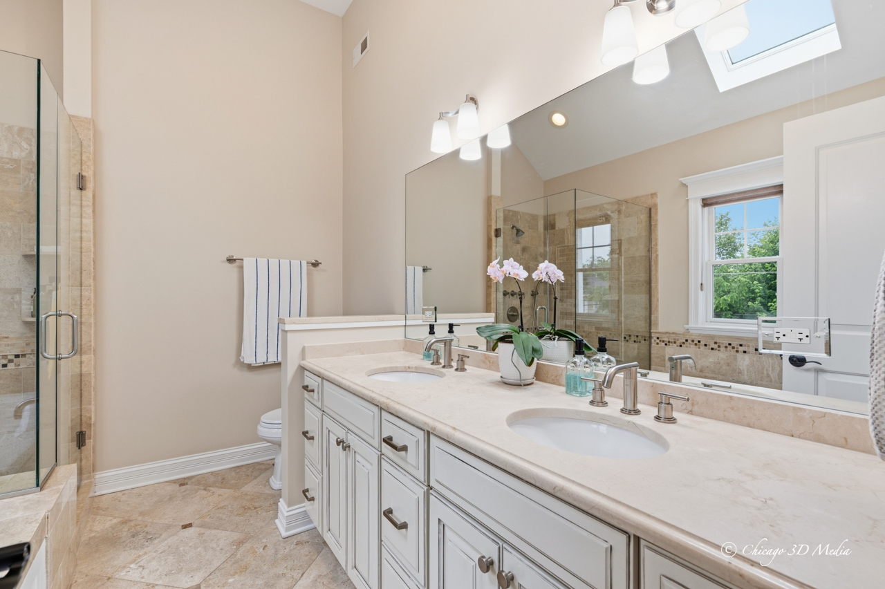 306 17th Street Wilmette, IL 60091 - Photo 27 of 48 a bathroom with a double vanity sink and a mirror