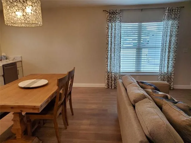 a view of a dining room with furniture and window