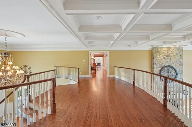a living room with fireplace furniture and a wooden floor