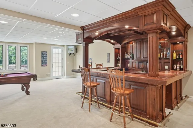 a room with lots of wooden furniture and a ceiling fan