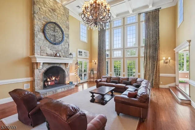 a living room with furniture a large window and a fireplace