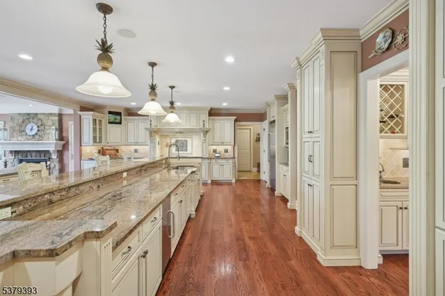 a large kitchen with stainless steel appliances lots of counter space and wooden floors