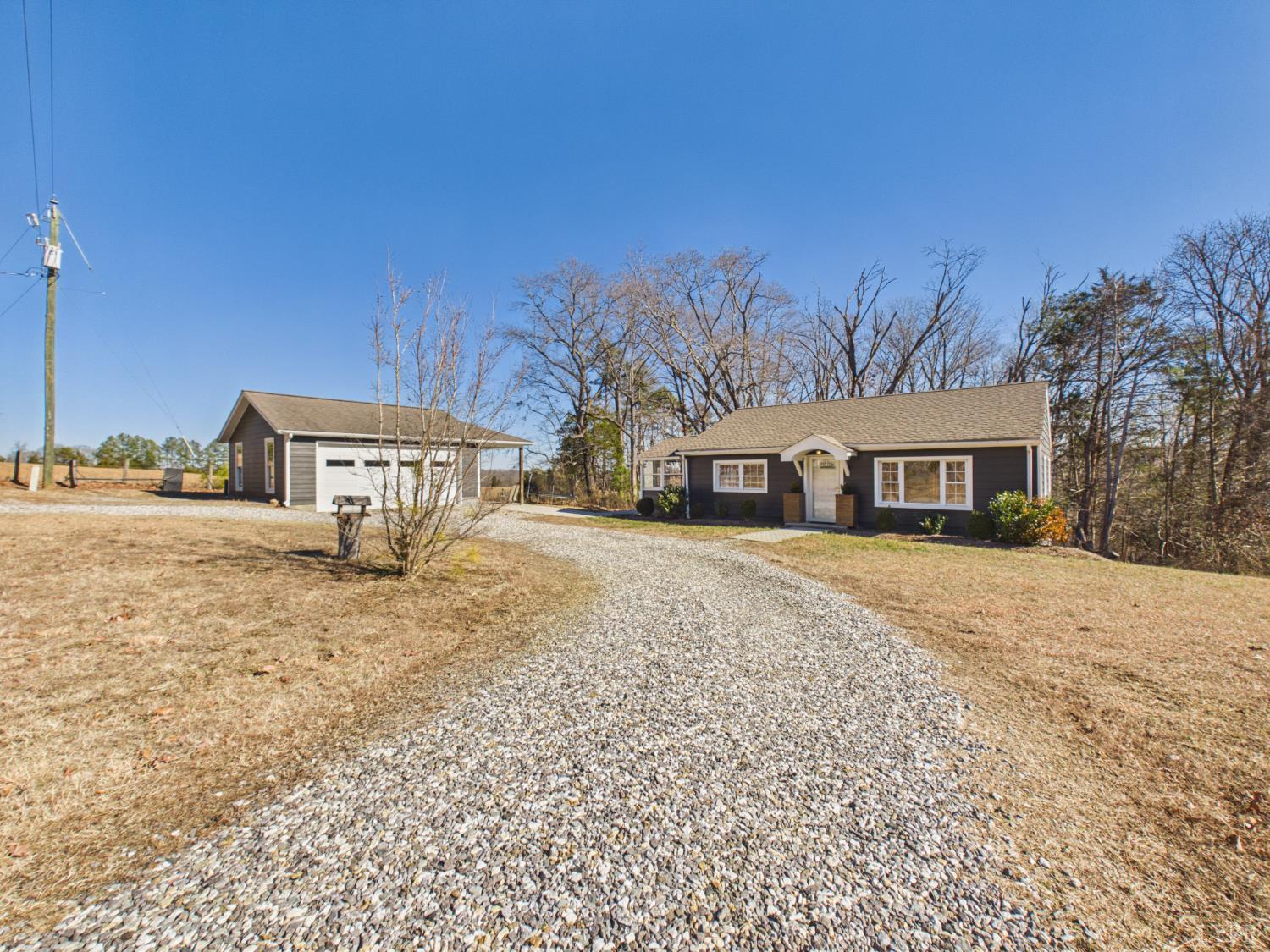 a yellow house with trees in front of it
